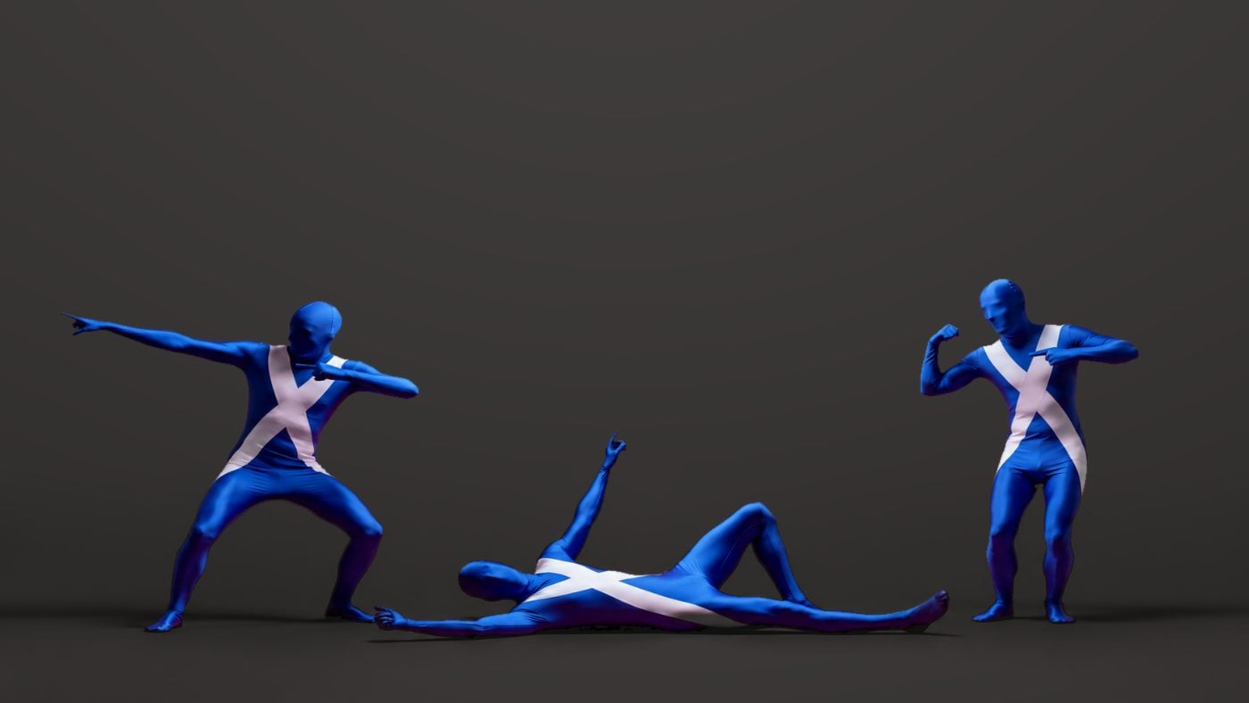 Three Saltire-print Morphsuits on a charcoal studio backdrop